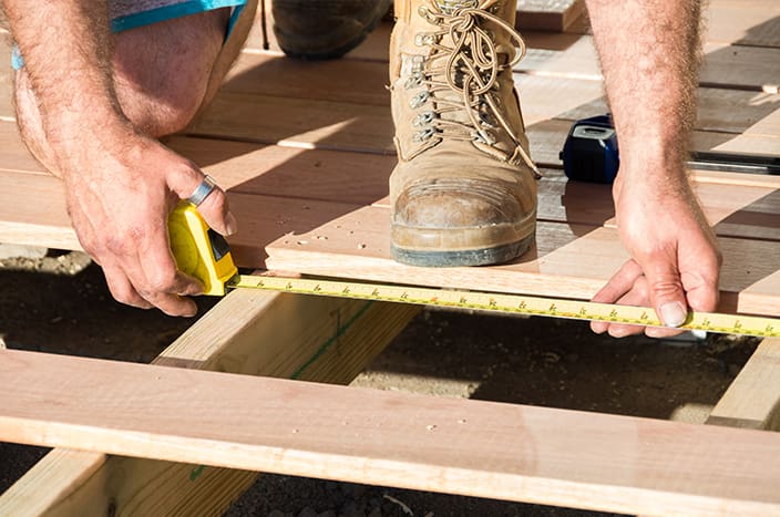 Man measuring decking for home renovations
